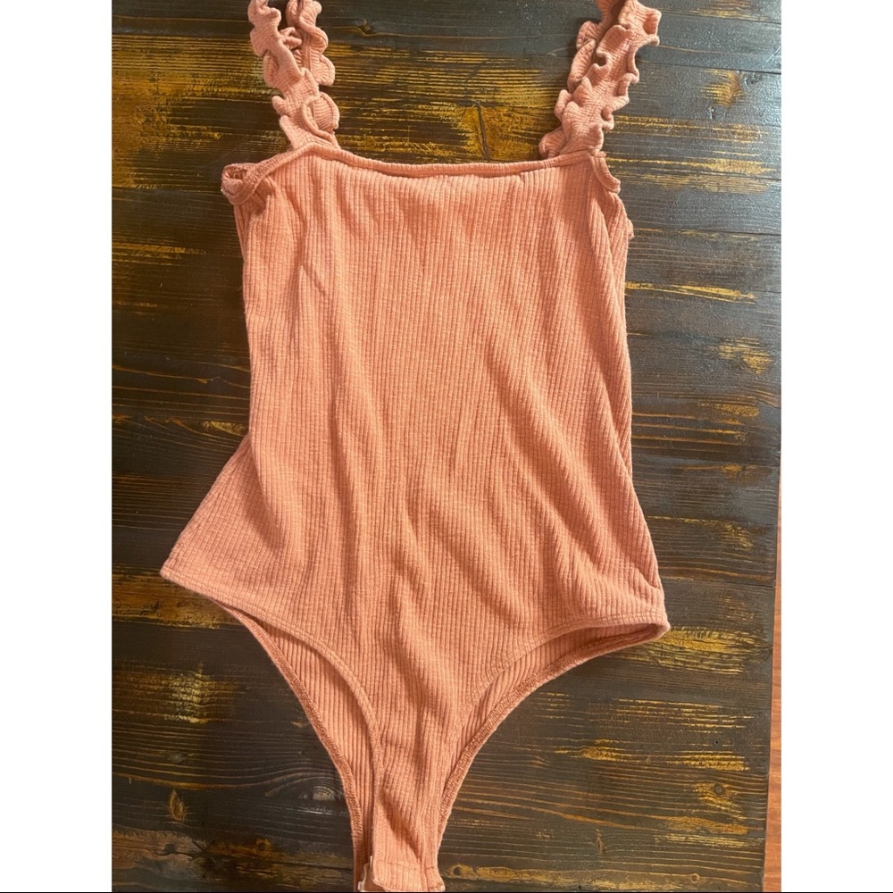 Peach colored body suit